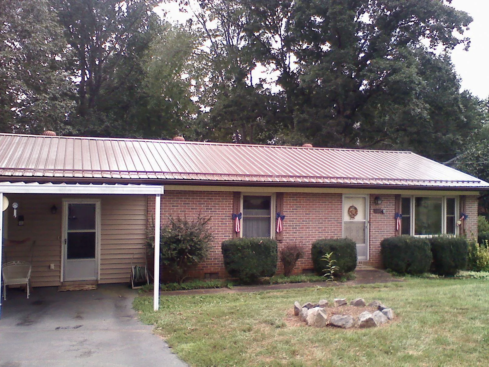 Bronze metal roof and carport on a brick ranch home — Roof Repair work by our crew in Twin Peaks