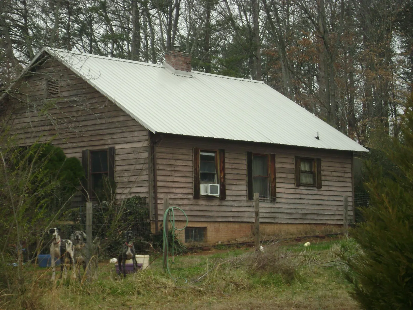 White metal roof on an old wood sided farmhouse, from a Metal Roof Installation job in Twin Peaks
